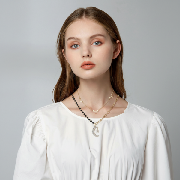 Woman wearing Solisita Gold Star and Moon Layered Necklace